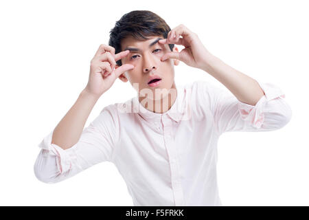 Tired man propping his eyes with hands Stock Photo