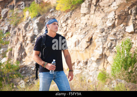 The man in the mountains with a bottle of water Stock Photo