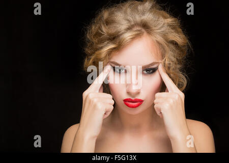 face of beautiful woman pointing at  her forehead Stock Photo