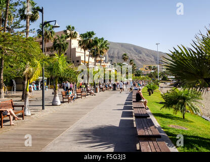 People walking along the Los Cristianos promenade Stock Photo