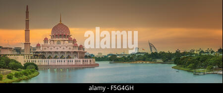 Sunset over Putrajaya Mosque and Panorama of Kuala Lumpur, Malaysia. Stock Photo