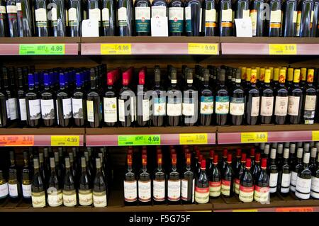 Supermarket wine shelves showing a selection of bottles of wine with price labels. Stock Photo