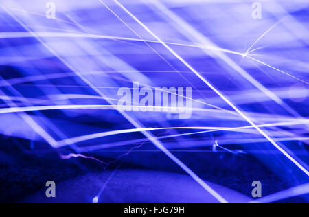 Flowing Sparks, photo with a slow shutter speed, blue tinted abstract background Stock Photo