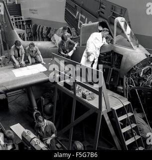 1960s, historical, in an aircraft hangar, young male aviation engineering apprentices or students working on an aircraft's engine under supervision of an instructor at Short Brothers in Belfast, Northern Ireland. Stock Photo