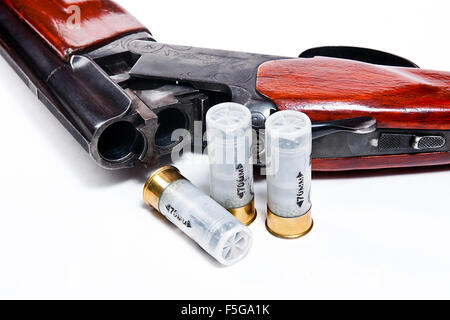 Hunting shotgun and ammunition on white background. Cartridges for hunting rifle. Close up view showing mechanism of hunting rif Stock Photo