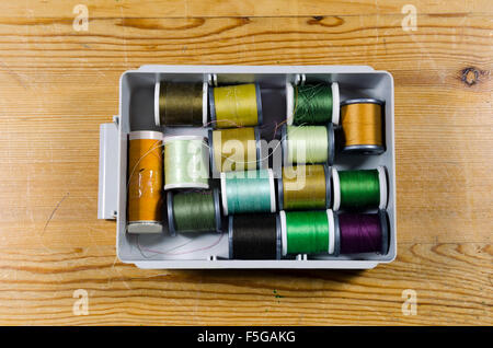 Box with a lot of reels of cotton in different color, photo from the North of Sweden. Stock Photo
