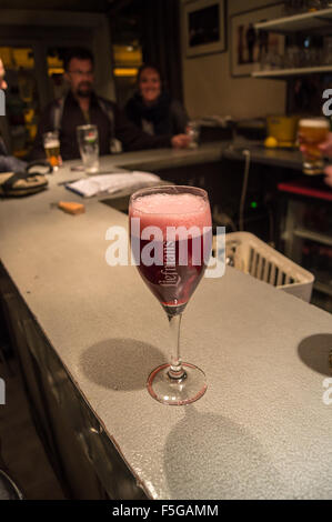 A printed glass of Liefmans Kriek craft beer on a zinc bar, Bar du Midi, Amiens, Somme, Picardie, France pub table drinks glasses Stock Photo