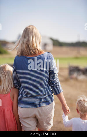 Sweden, Gotland, Faro, Mother with son (2-3) and daughter (10-11) holding hands