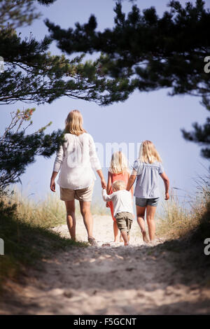 Sweden, Gotland, Faro, Skar, Mother with son (2-3) and daughters (8-9, 10-11) walking along footpath