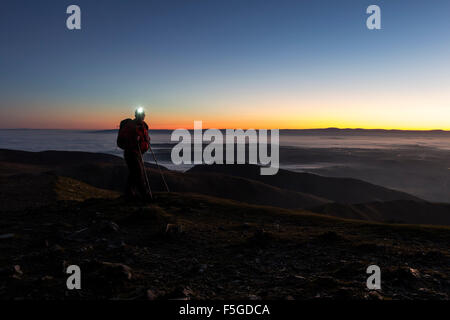 Hiker with Head Torch on the Summit of Blencathra in the Dark Lake District Cumbria UK Stock Photo