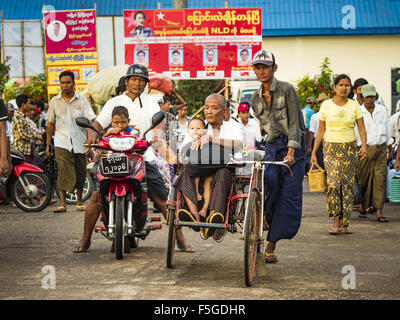 Yangon, Yangon Division, Myanmar. 4th Nov, 2015. A pedicab driver picks up a fare in front of a NLD poster in Dala, a working class suburb of Yangon. National elections are scheduled for Sunday Nov. 8 in Myanmar. The two principal parties are the National League for Democracy (NLD), the party of democracy icon and Nobel Peace Prize winner Aung San Suu Kyi, and the ruling Union Solidarity and Development Party (USDP), led by incumbent President Thein Sein. There are more than 30 parties campaigning for national and local offices. © Jack Kurtz/ZUMA Wire/Alamy Live News Stock Photo