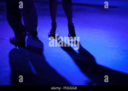 Detail of shoes with shadows in milonga ballroom. Stock Photo