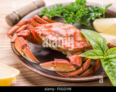 Seafood dish - cooked crab with lemon and herbs. Stock Photo