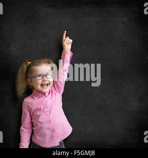 kid in glasses on school chalkboard Stock Photo