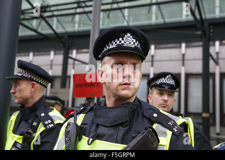 London, UK. 4th November, 2015. A student protest in central London against fees and many other issues. A policeman surveys the demonstration anxiously, outside the department for business just after an incident between police and protesters.copyright Carol Moir/Alamy Live News Stock Photo