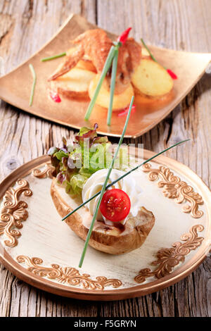 Baked potato with cream cheese garnished with lettuce Stock Photo