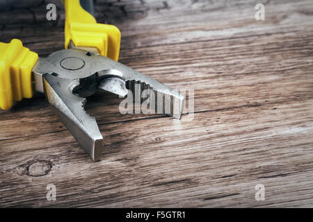 multitool pliers on wooden background Stock Photo