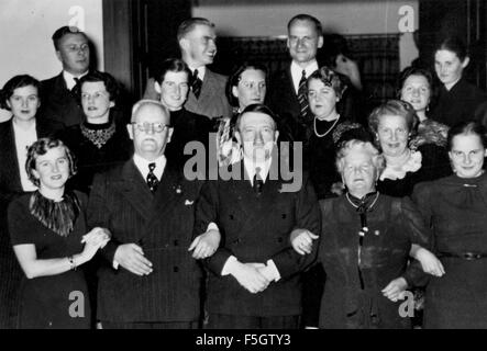 EVA BRAUN at left links arms with Franz Xaver Schwarz, Treasurer of the Nazi Party, while Mrs Schwarz puts her arm round Adolf Hitler about 1943. Stock Photo