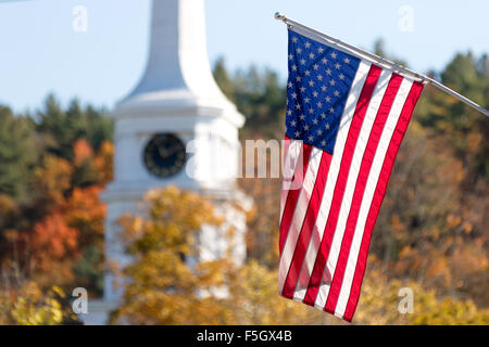 American flag flying in front of Stowe Community Church, in autumn, Stowe, Vermont USA Stock Photo