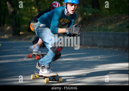 Man on a longboard moving fast during DH - Race contest in Kiev, Ukraine Stock Photo