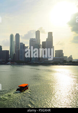 Boat in  Singapore bay in the sunset light. Stock Photo