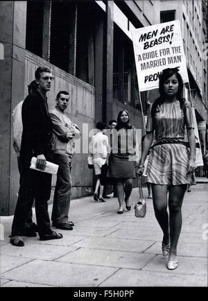 1982 - A New eye-opener for the West End: There was a new scene in London's swinging West End today, when London crowds saw a new conception in sandwich board advertising eight beautiful young mini-skirted models. These swinging chicks paraded around the West End carrying specially made lightweight sandwich boards advertising 20th. Century-Fox's new comedy ''A guide For the Married Man'', which opens today at the Carlton Cinema, Haymarket. Photo shows one of the girls, 18 year old Mandy Corry, of Willesden recieved some admiring glances as she paraded with her sandwich board in the West End to Stock Photo