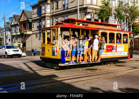 People riding the famous San Francisco cable cars, the last manually operated cable car system in the World Stock Photo