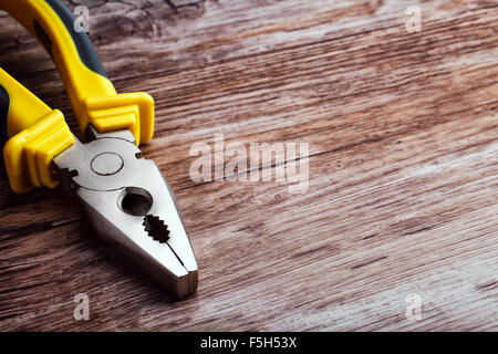 multitool pliers on wooden background Stock Photo