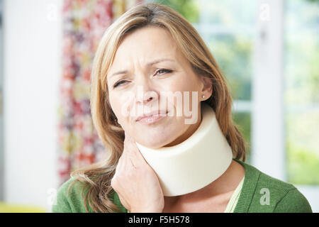 Woman Wearing Surgical Collar In Pain Stock Photo