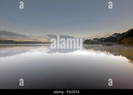 The Pier at Howtown on Ullswater lake during mist at dawn, Lake District National Park, Cumbria, England, Uk, Gb. Stock Photo