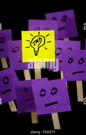 conceptual image of a good idea standing out using sticky notes with hand drawn questions marks and a light bulb Stock Photo