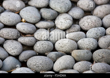 Charcoal lava pebbles background Stock Photo
