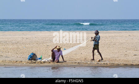 Traditional fisherman in canoe in Batticaloa, Sri Lanka Stock Photo