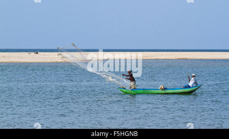 Traditional fisherman in canoe in Batticaloa, Sri Lanka Stock Photo