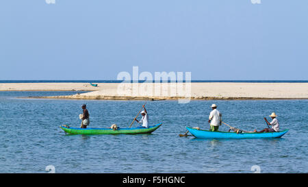 Traditional fisherman in canoe in Batticaloa, Sri Lanka Stock Photo