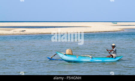 Traditional fisherman in canoe in Batticaloa, Sri Lanka Stock Photo