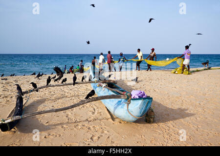 Traditional fisherman in canoe in Batticaloa, Sri Lanka Stock Photo