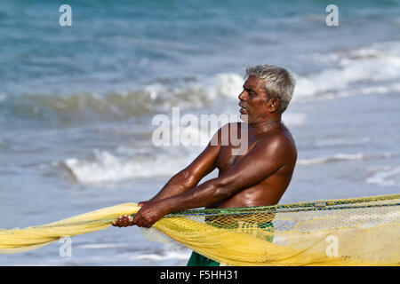 Traditional fisherman in canoe in Batticaloa, Sri Lanka Stock Photo