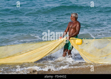 Traditional fisherman in canoe in Batticaloa, Sri Lanka Stock Photo