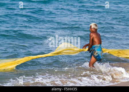 Traditional fisherman in canoe in Batticaloa, Sri Lanka Stock Photo