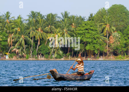 Traditional fisherman in canoe in Batticaloa, Sri Lanka Stock Photo