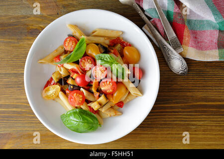 penne with roasted eggplant and tomato, top view Stock Photo