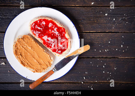 Peanut butter and jelly sandwich on a rustic table. Photographed from directly above. Stock Photo