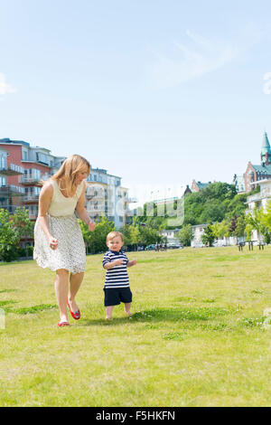 Sweden, Sodermanland, Nacka, Finnboda Hamn, Mother with baby boy (18-23 months) in park Sweden, Sodermanland, Nacka, Finnboda Hamn, Mother with baby boy (18-23 months) in park