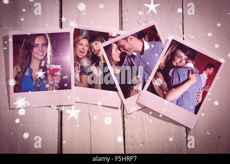 Composite image of instant photos on wooden floor Stock Photo