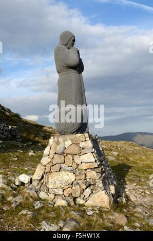 Statue of St Patrick at the summit of a rugged pilgrims trail Maumturk Mountains Connemara County Galway Ireland Stock Photo