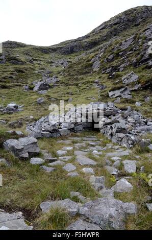 St Patricks Holy Well at the summit of a rugged track through the Maumturk Mountains Connemara Iirealnd Stock Photo