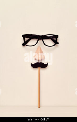 eyeglasses, nose and mustache, depicting a man face, on a beige background Stock Photo