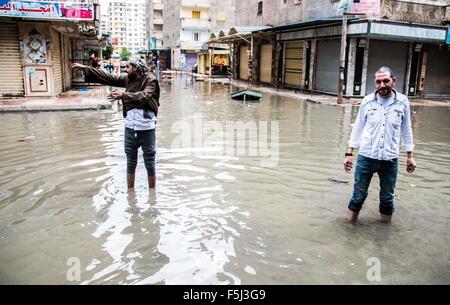 Alexandria, Alexandria, Egypt. 5th Nov, 2015. Egyptians walk in a flooded road following heavy rain storm, in Alexandria, Egypt, November 5, 2015. Eleven people were killed in floods in Beheira province north of Cairo, a security source said, and authorities evacuated 100 people from a village in the province as Egypt suffers from a second round of stormy weather in less than a month Credit:  Amr Sayed/APA Images/ZUMA Wire/Alamy Live News Stock Photo