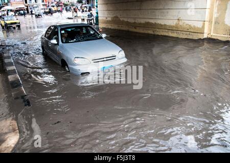 Alexandria, Alexandria, Egypt. 5th Nov, 2015. An Egyptian man drives in a flooded road following heavy rain storm, in Alexandria, Egypt, November 5, 2015. Eleven people were killed in floods in Beheira province north of Cairo, a security source said, and authorities evacuated 100 people from a village in the province as Egypt suffers from a second round of stormy weather in less than a month Credit:  Amr Sayed/APA Images/ZUMA Wire/Alamy Live News Stock Photo